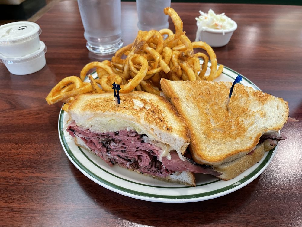 Classic deli sandwich piled with meat, toasted bread and fries